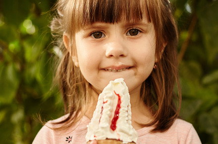 Cute Little girl eating delicious ice-cream in the city park on a summer sunny, a Person Photo by Rohan Photography