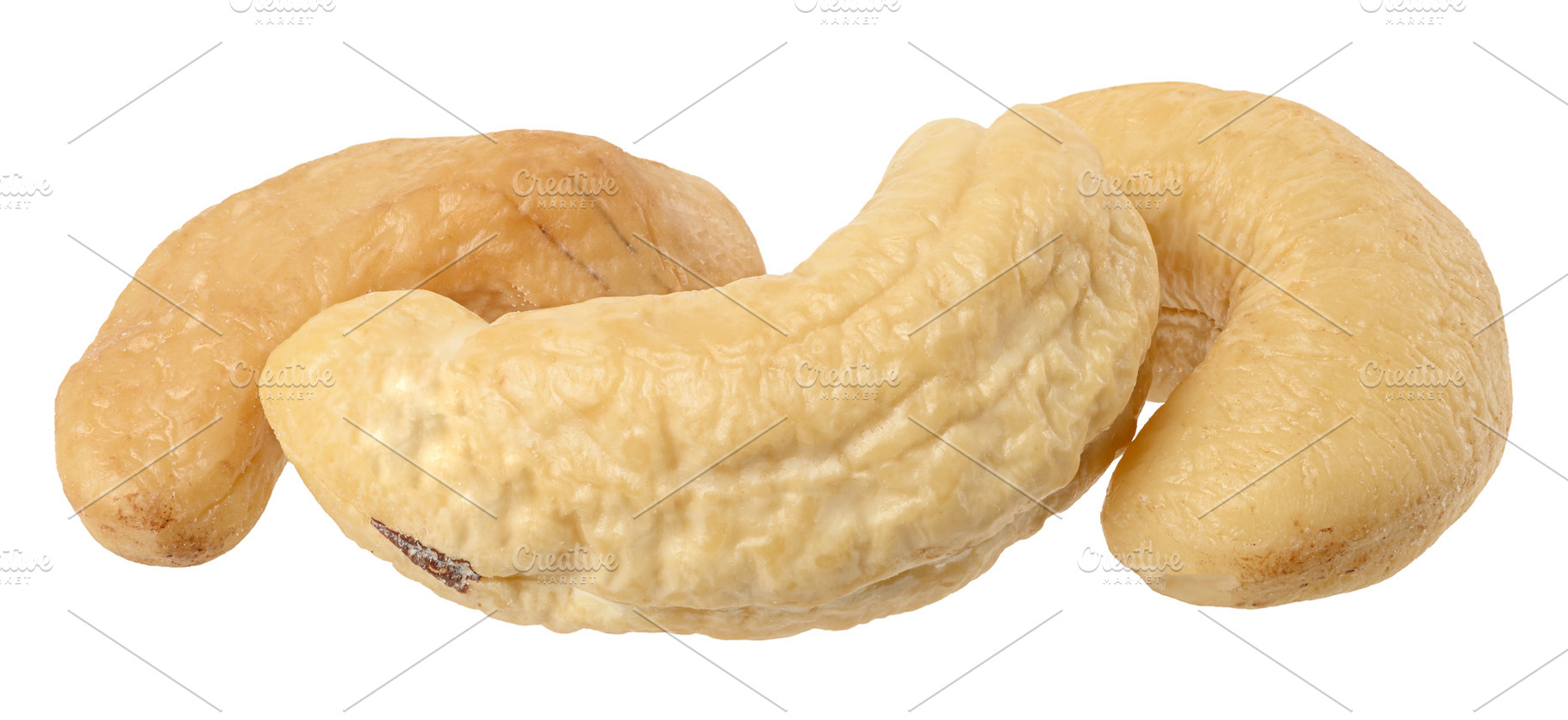Three whole light cream colored cashew nut kernels on an isolate, a Food & Drink Photo by ndanko