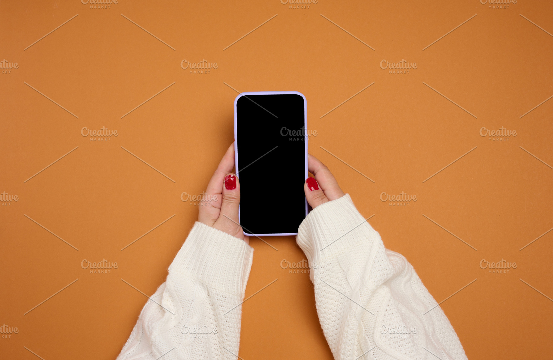 A woman's hands in a white knitted sweater hold a mobile phone w, a Technology Photo by ndanko