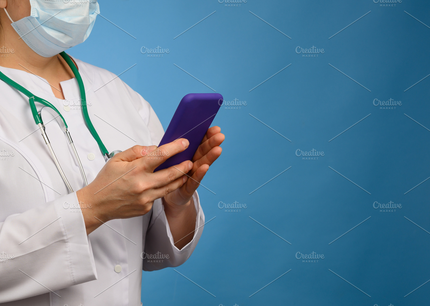 A medical worker in a mask and white coat holding a stethoscope,, a Person Photo by ndanko