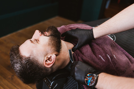 Shaving with straight razor in barbershop, a Person Photo by progressman