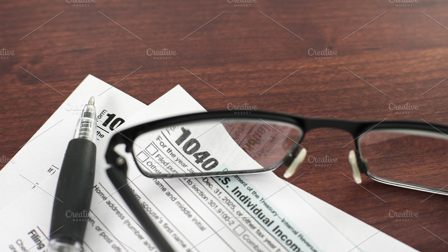Documents on a table with glasses as, a Business Photo by 1miromiro