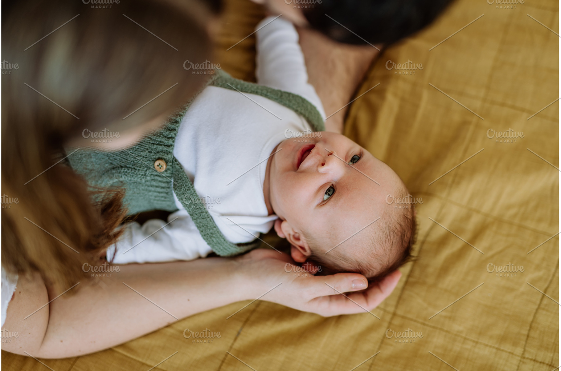 Happy parents cuddling with their, a Person Photo by HalfPoint