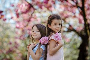 Sisters back to back in spring, a Person Photo by HalfPoint