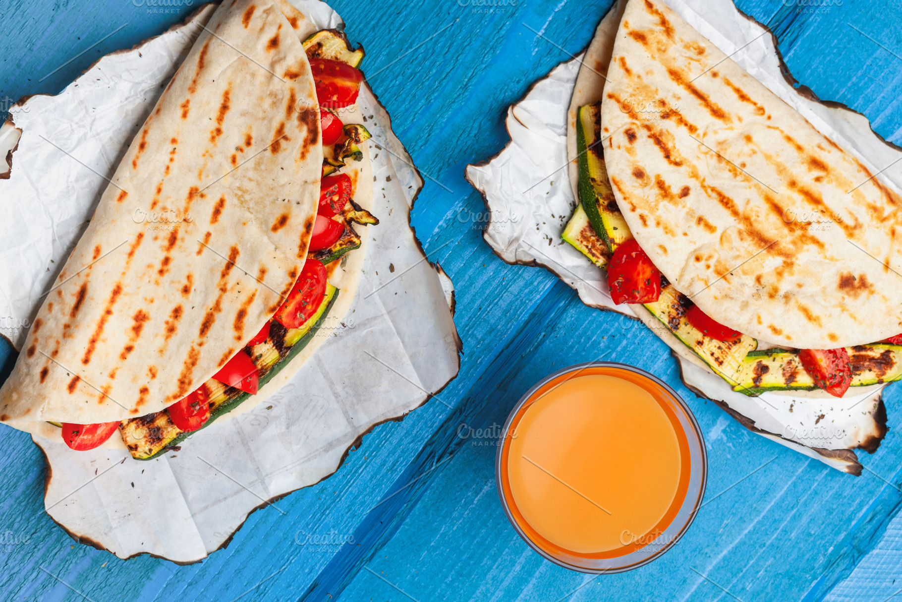 Piadina with Grilled Zucchini and Cherry Tomatoes Served with Orange Juice, a Food & Drink Photo by Antonio Gravante Market