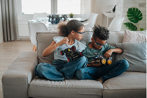 Siblings building robotic car at, a School & Education Photo by HalfPoint