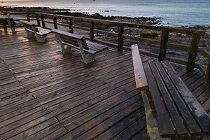 Promenade stop with wooden seats at coast of atlantic ocean, pun, a Holiday Photo by DanFLCreativo