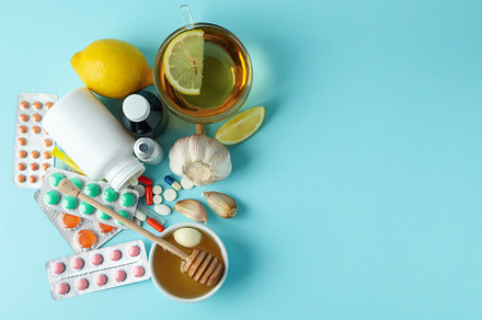 Concept of treatment colds with honey and garlic on blue backgro, a Health & Medical Photo by AtlasStudio PRO
