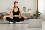 Black Woman At Laptop Sitting In Lotus Position Meditating Indoors, a Photo by Prostock-Studio (Thumbnail 2 of 2)