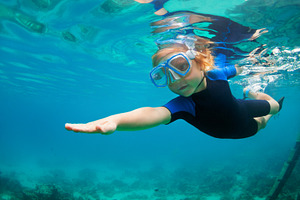 Child dive in snorkeling mask featuring family, holiday, and beach