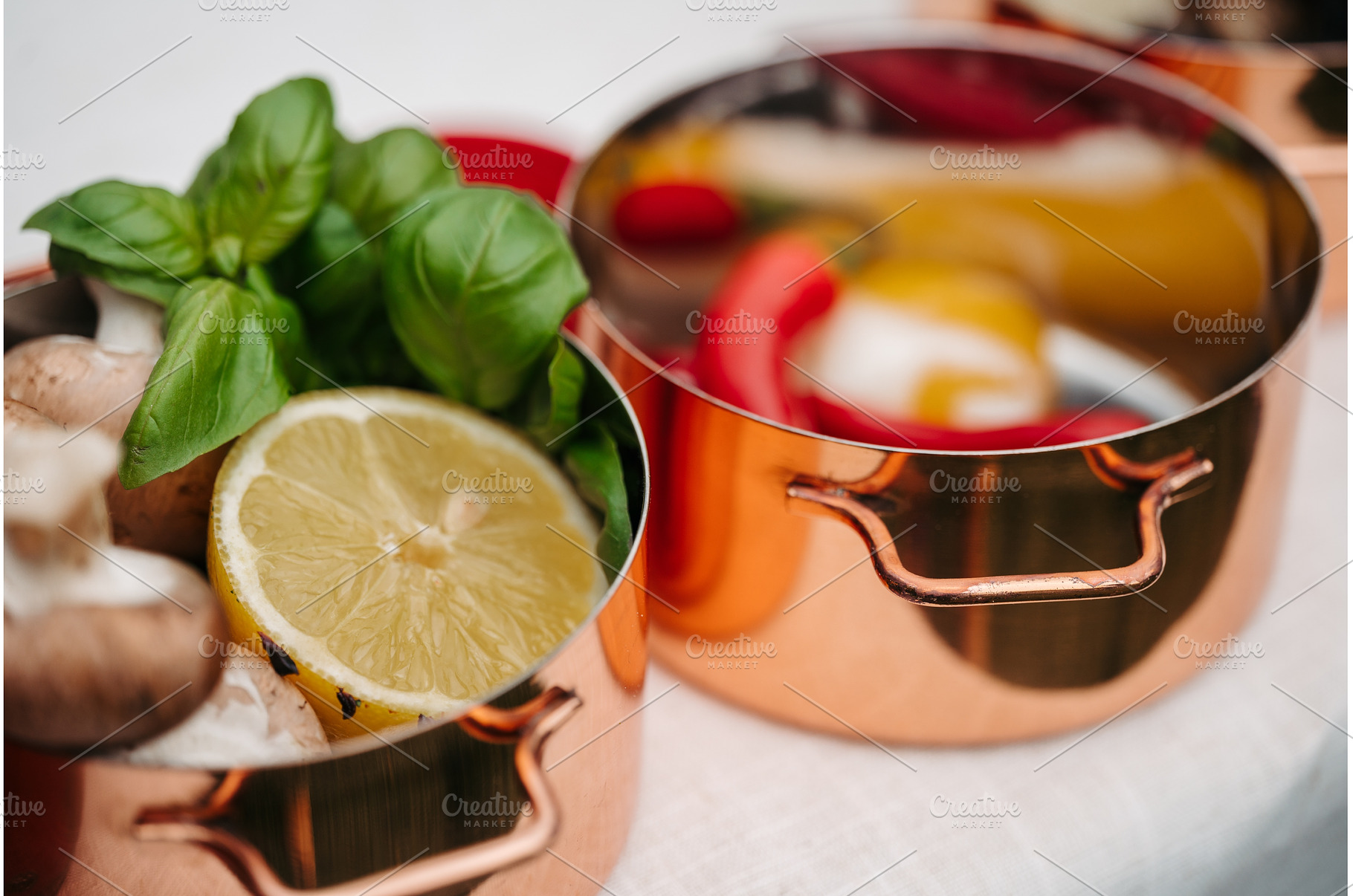 Fresh ingredients in copper pots, a Food & Drink Photo by HalfPoint