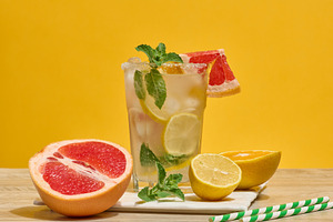 Glass with a cold drink, grapefruit slices, ice, mint and lemon, a Food & Drink Photo by ndanko