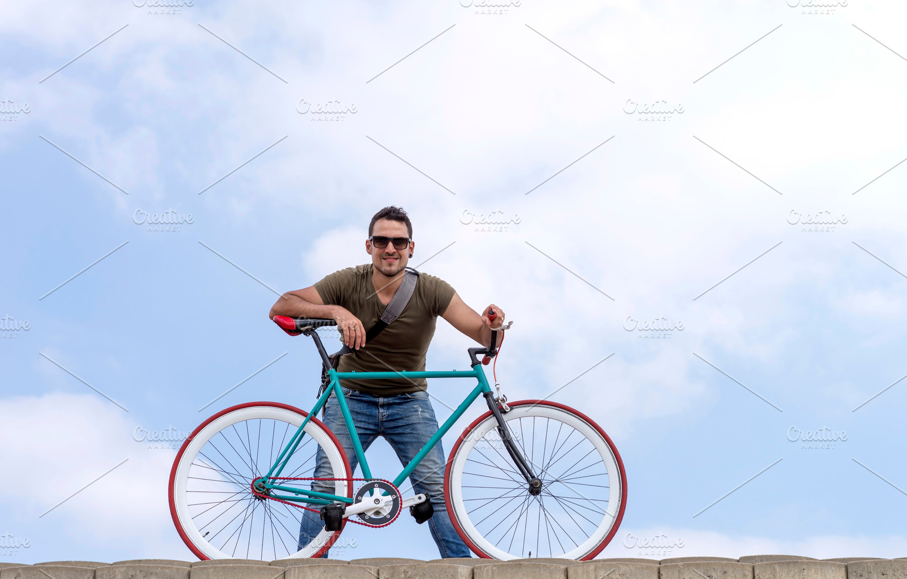 Urban man wearing sunglasses on a cloudscape, a Holiday Photo by 2Design