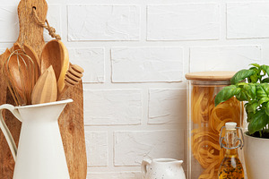Kitchen utensils, pasta and basil showing rustic cooking and hea, a Photo by Olena Rudo