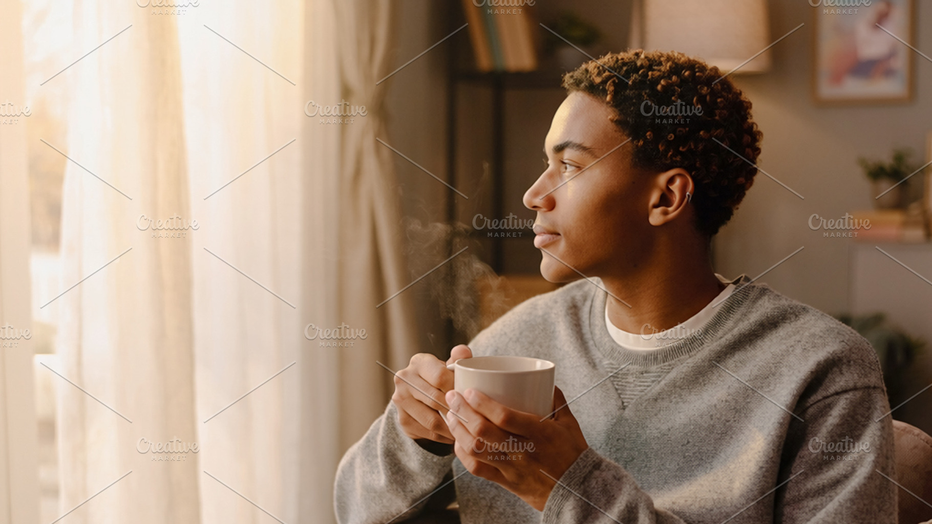 Person sitting near window with cup, a Photo by DanFLCreativo