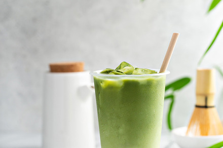 Cold matcha latte in a tall glass on marble, a Food & Drink Photo by farwasser