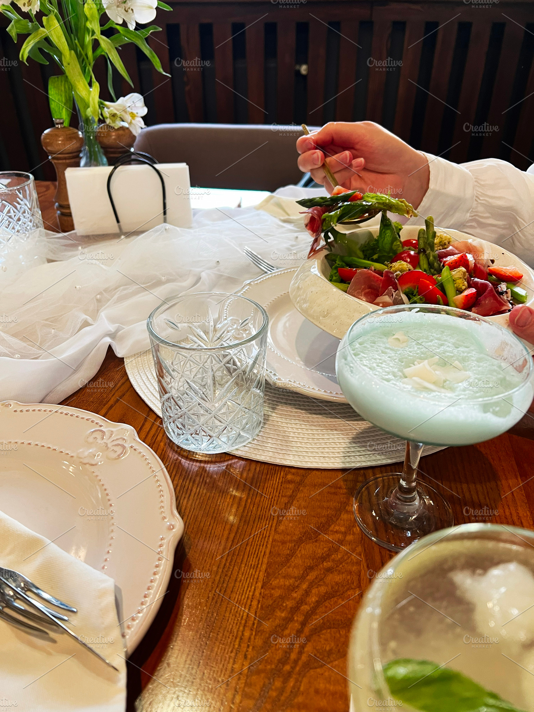 Elegant table setting with fresh salad and refreshing drinks for a pleasant mea, a Photo by AS photostudio