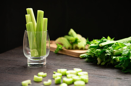 Bunch of fresh celery stalk on wooden table with leaves prepared, a Food & Drink Photo by Ministocker
