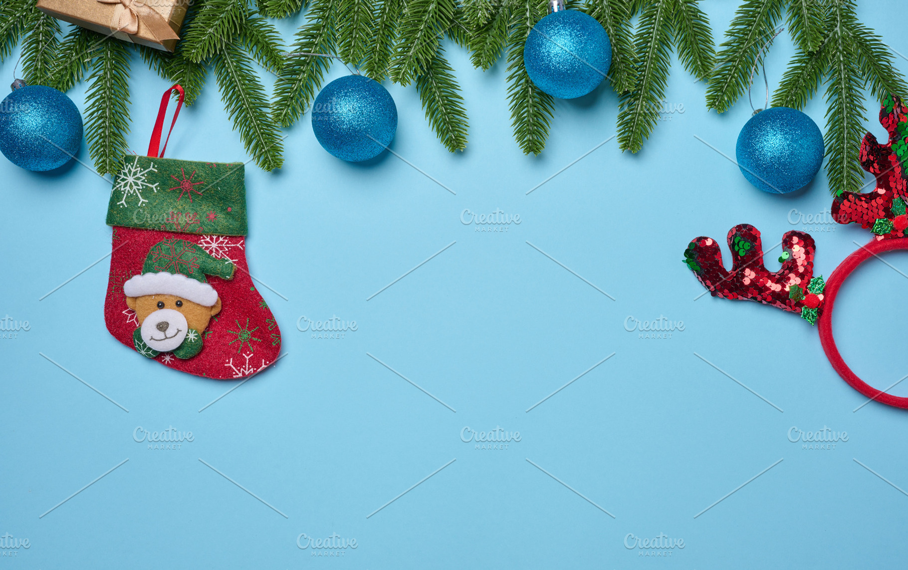 Spruce branches and Christmas toys on a blue background, top vie, a Holiday Photo by ndanko