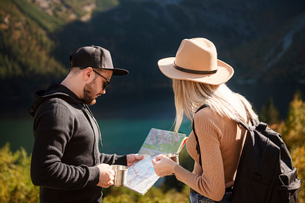 Young tourist couple, man and woman, on hiking path in mountains, a Person Photo by Olena Rudo