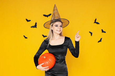 Concept of Halloween, young woman on yellow background, a Person Photo by AtlasStudio PRO