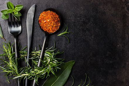 Food black background with herbs spices and cutlery top view containing food, a Food & Drink Photo by LARISA BLINOVA