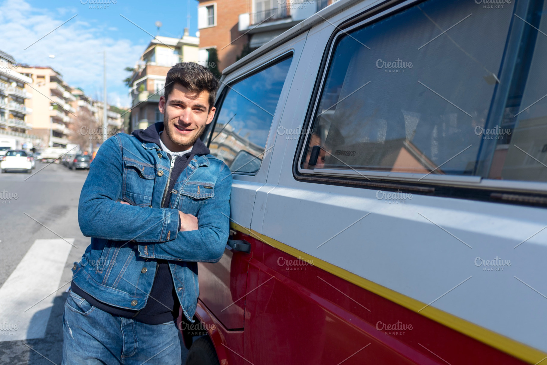 A Happy young man leaning at the retro mini van, a Holiday Photo by 2Design