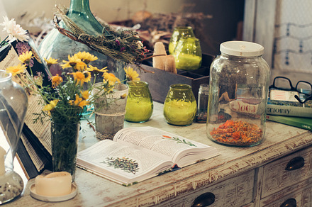 Jars with plant infusions containing chamomile, honey, and lemon