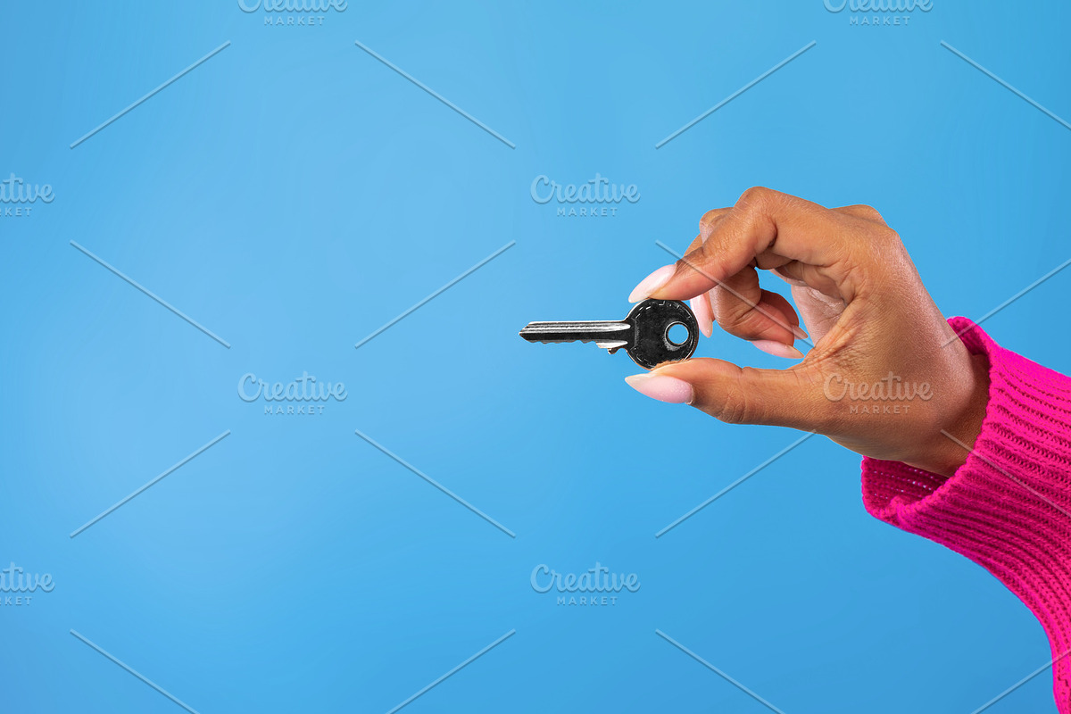Cropped view of young black woman holding metal house key on blue studio backgr, a Photo by Prostock-Studio (Photo 2 of 2)