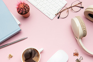 Pastel pink desk with coffee, headphones, and office supplies fr, a Business Photo by Olena Rudo