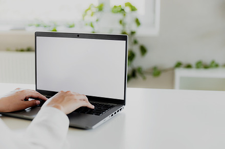 Woman hands typing on the laptop with blank white screen mockup laying on table, a Business Photo by Lenor4ik