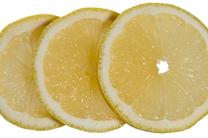 Close-up of three thin round lemon slices placed overlapping eac, a Food & Drink Photo by ndanko