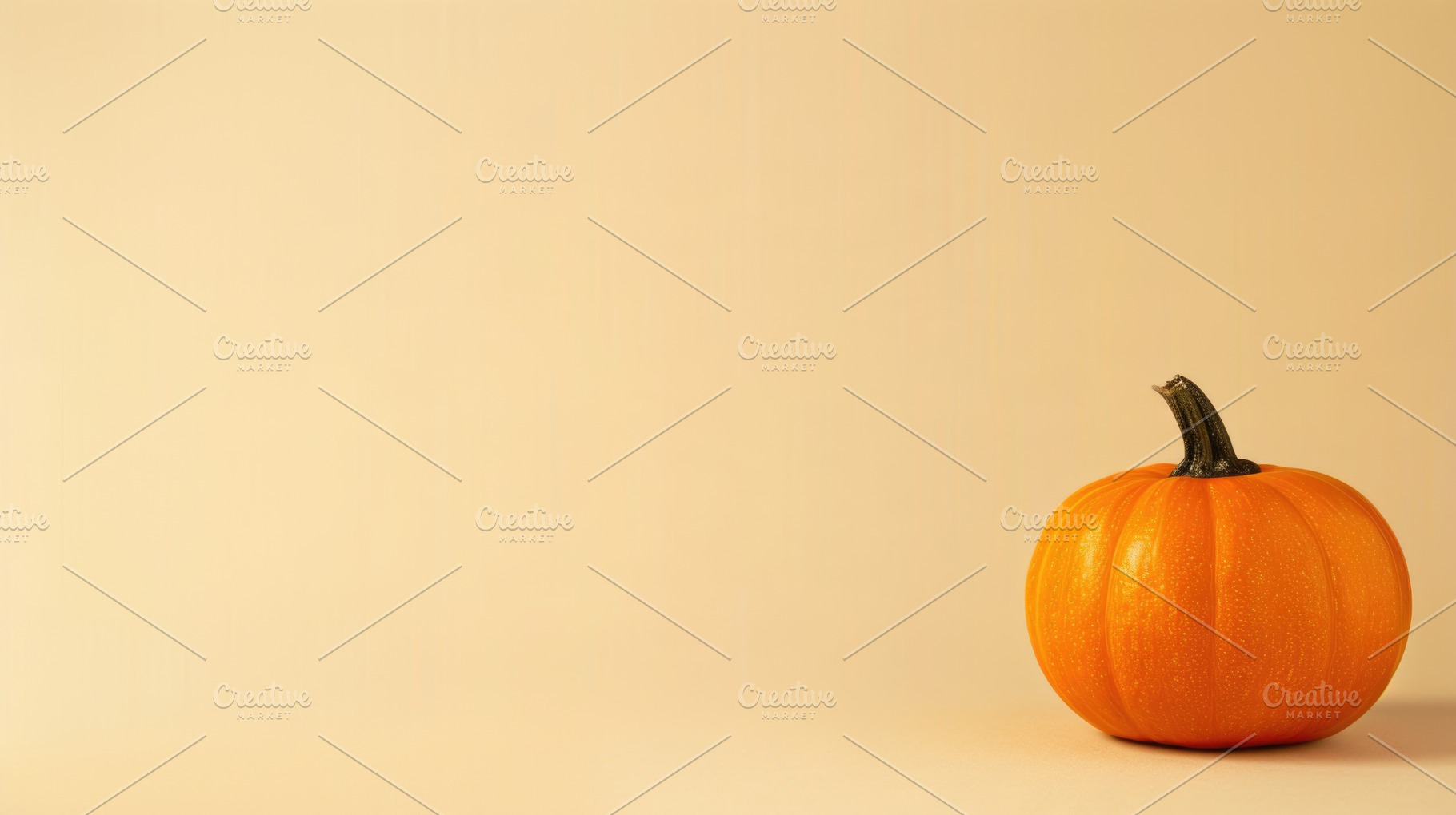 Single orange pumpkin on warm beige background with copy space, a Food & Drink Photo by José Manuel Gelpi