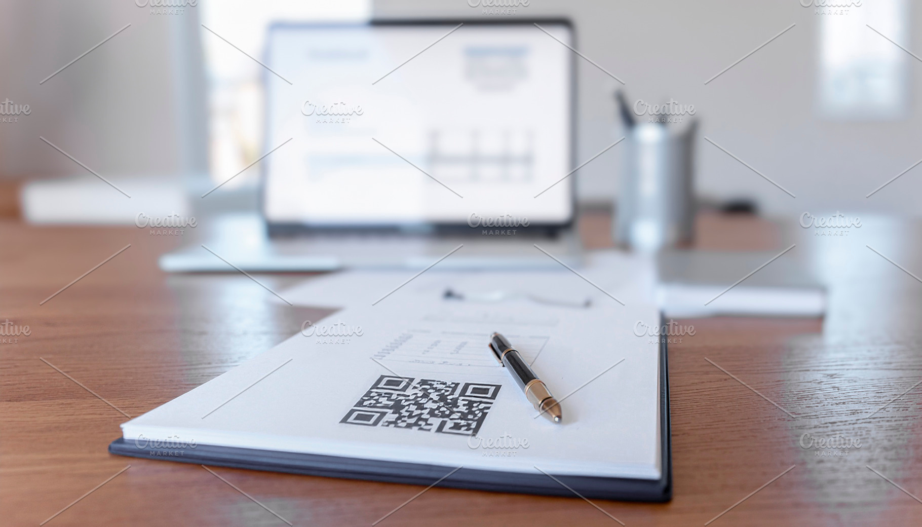 Desk showing a printed QR code on a paper document, a Business Photo by DanFLCreativo
