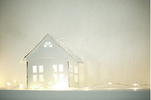 White miniature house illuminating a, a Holiday Photo by Anna Efetova