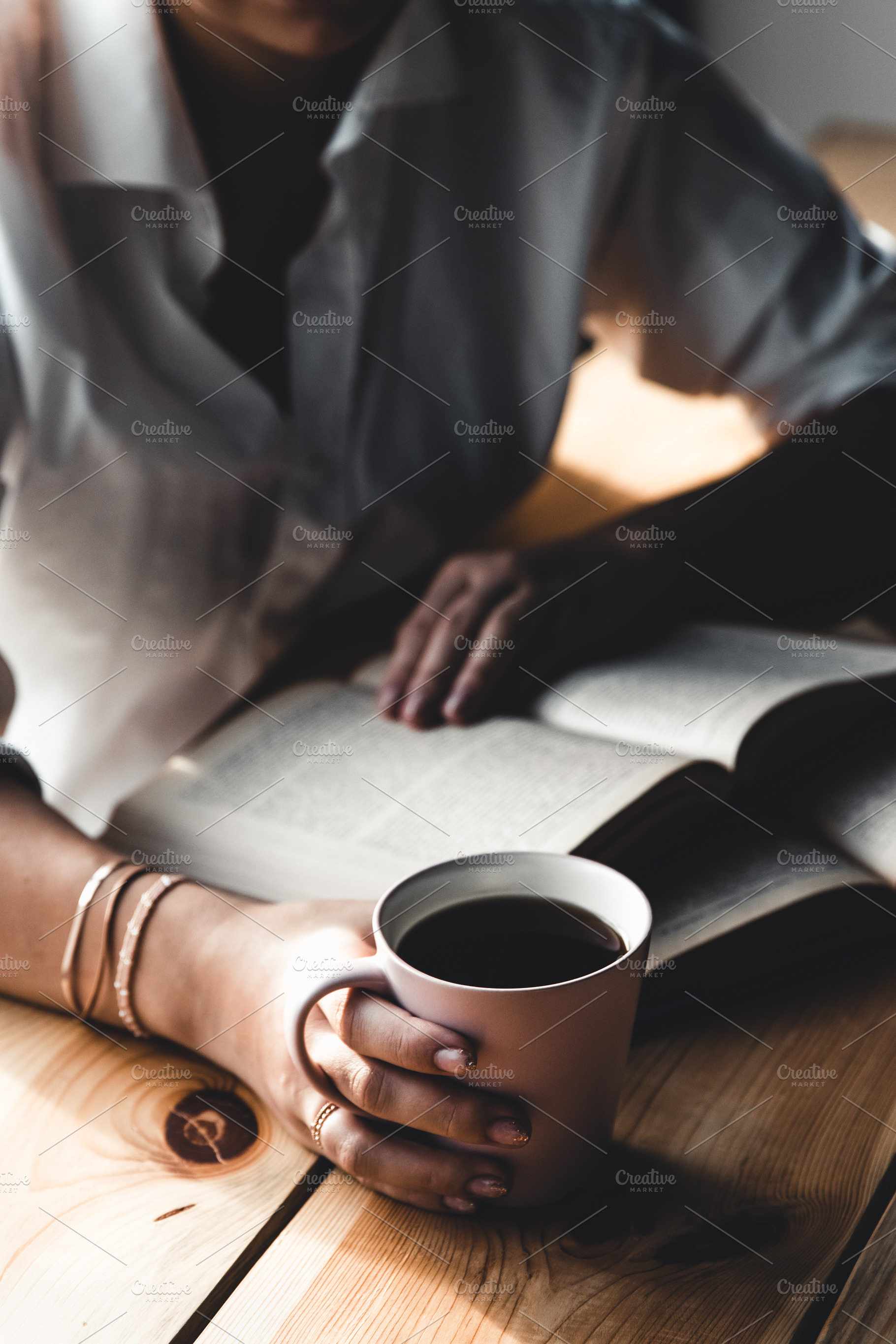 Woman reads book and drinks coffee stock photo containing background and woman, a School & Education Photo by OS