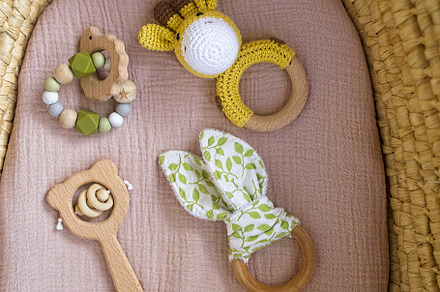 in a basket natural wooden knitted toys for a newborn. View from above