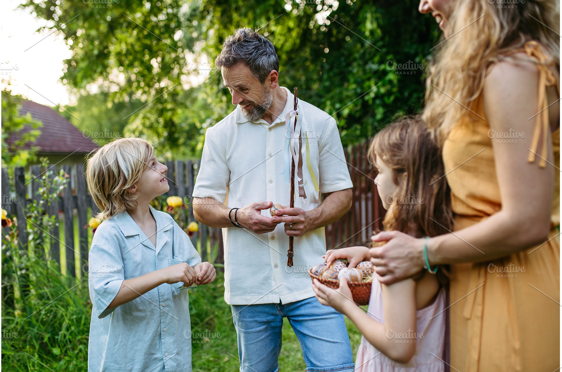 Girl rewarding boy with Easter eggs, a Holiday Photo by HalfPoint