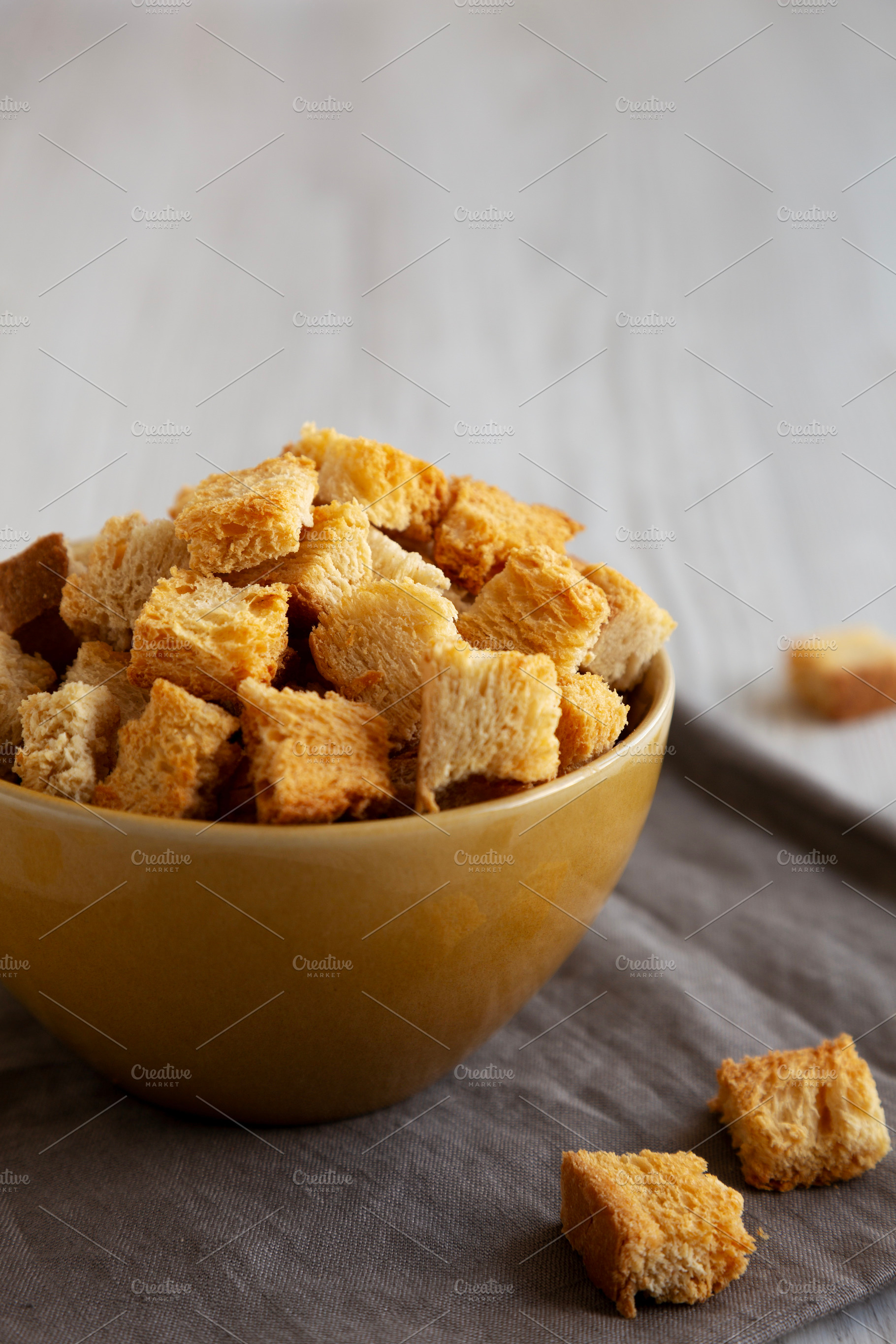 Homemade Crispy Bread Croutons in a Bowl, side view. Close-up., a Food & Drink Photo by LiudmylaChuhunova