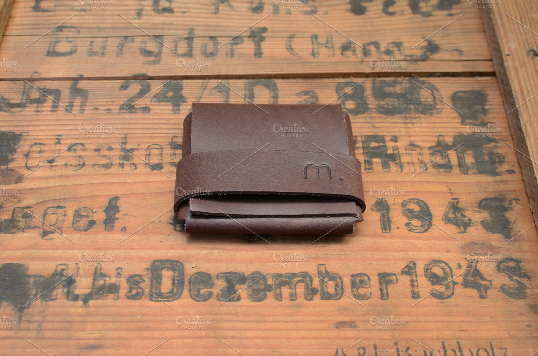 Leather wallet on wooden surface featuring leather, fashion, and design