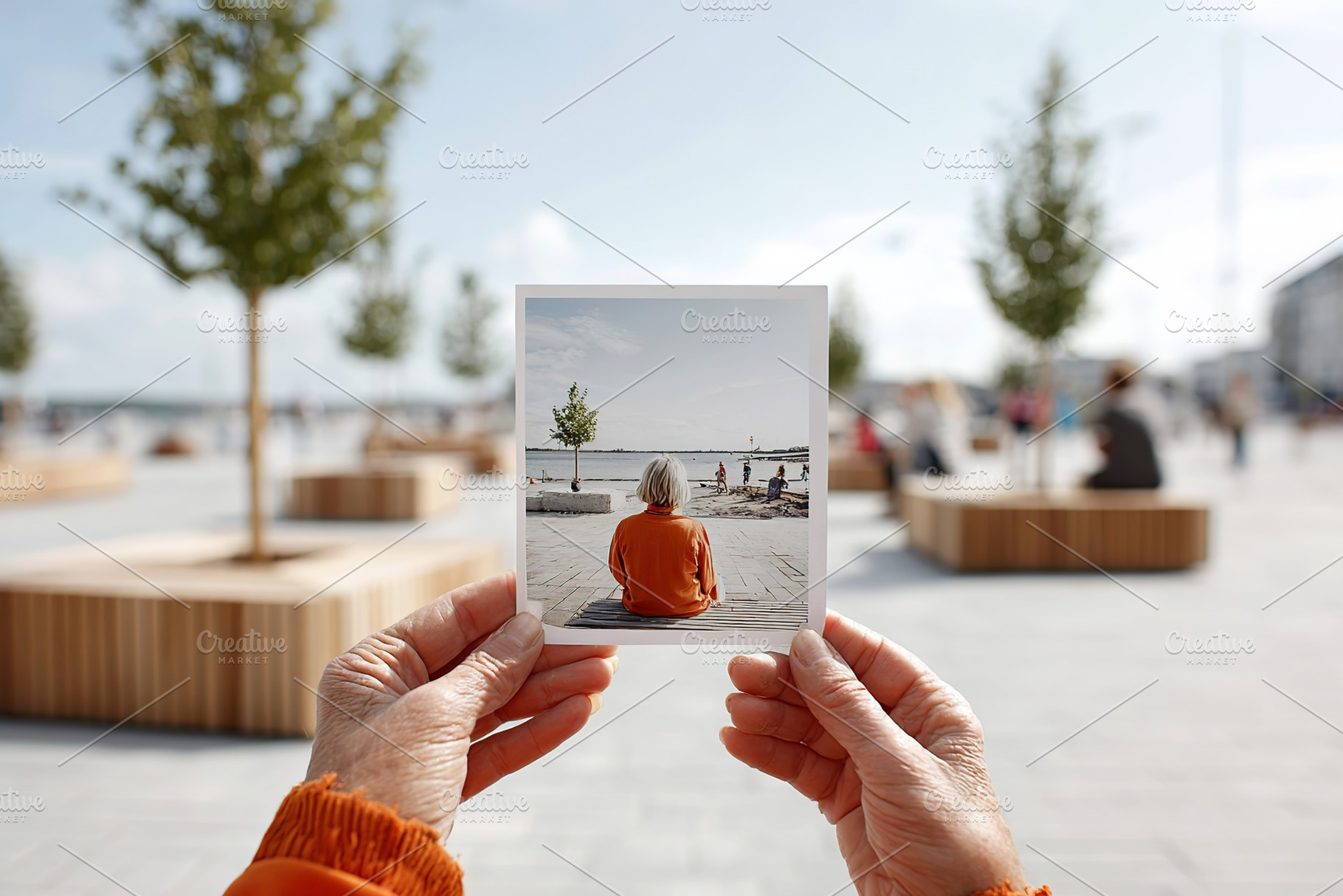 Young person holds mockup of a scene by the waterfront during a sunny day, a Photo by AlyaAnd