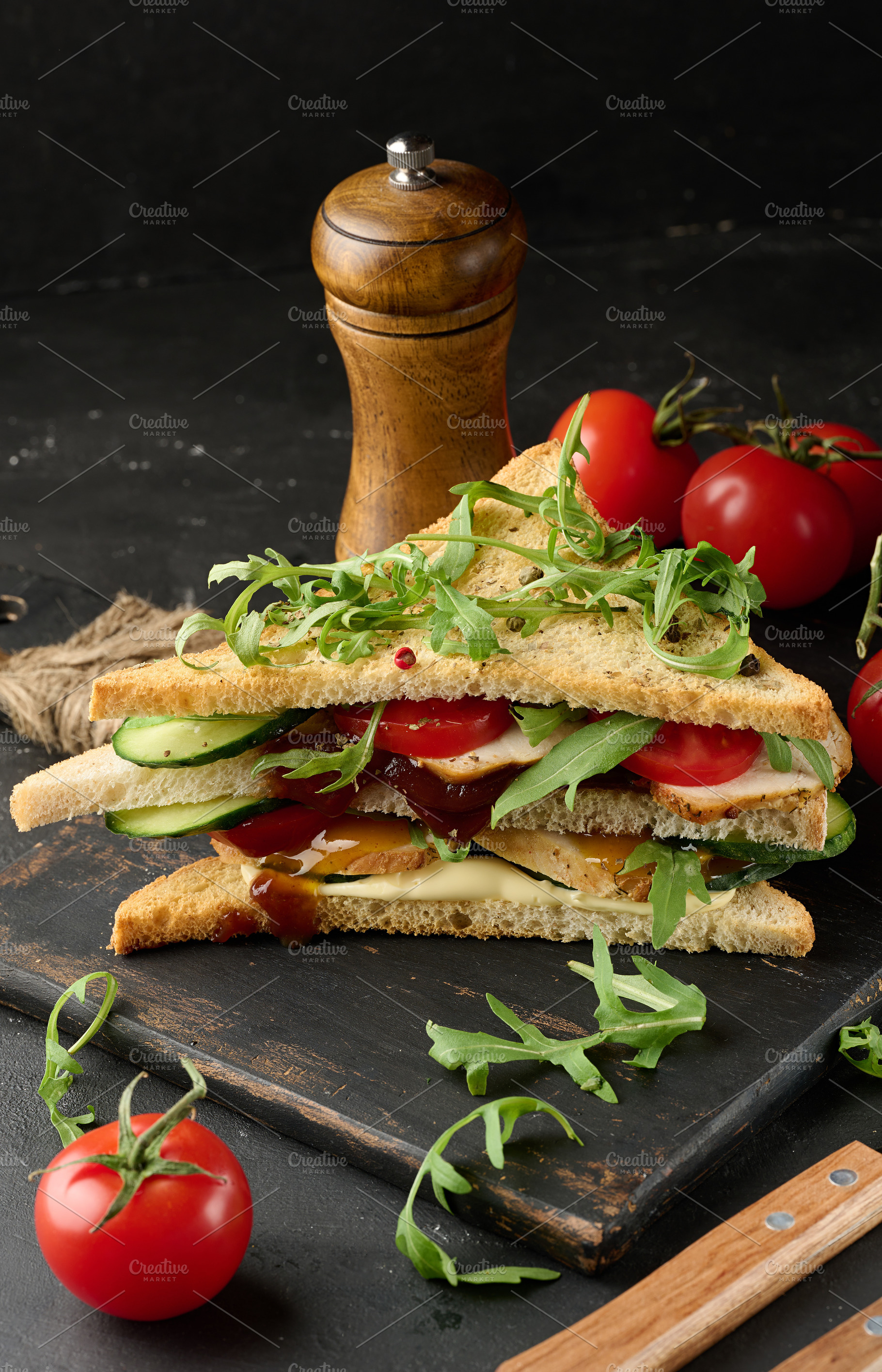 Grilled chicken sandwich with fresh tomatoes, cucumbers, arugula, a Food & Drink Photo by ndanko