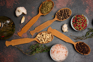 Various culinary spices in wooden spoons on brown background, to, a Food & Drink Photo by ndanko