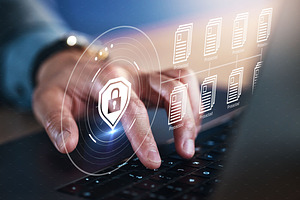 Cyber security, hand and document encryption on laptop with hologram and safety lock icon. Person with tech for privacy, hacking and access control shield programming for info, database or archive, a Photo by Peopleimages.com