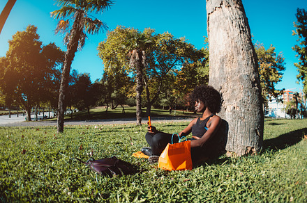 Black girl phoning in park, fish-eye, a Person Photo by SkyNext