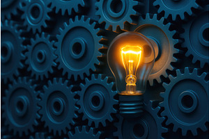 A glowing light bulb stands out, an Illustration by Sergey Kotenev