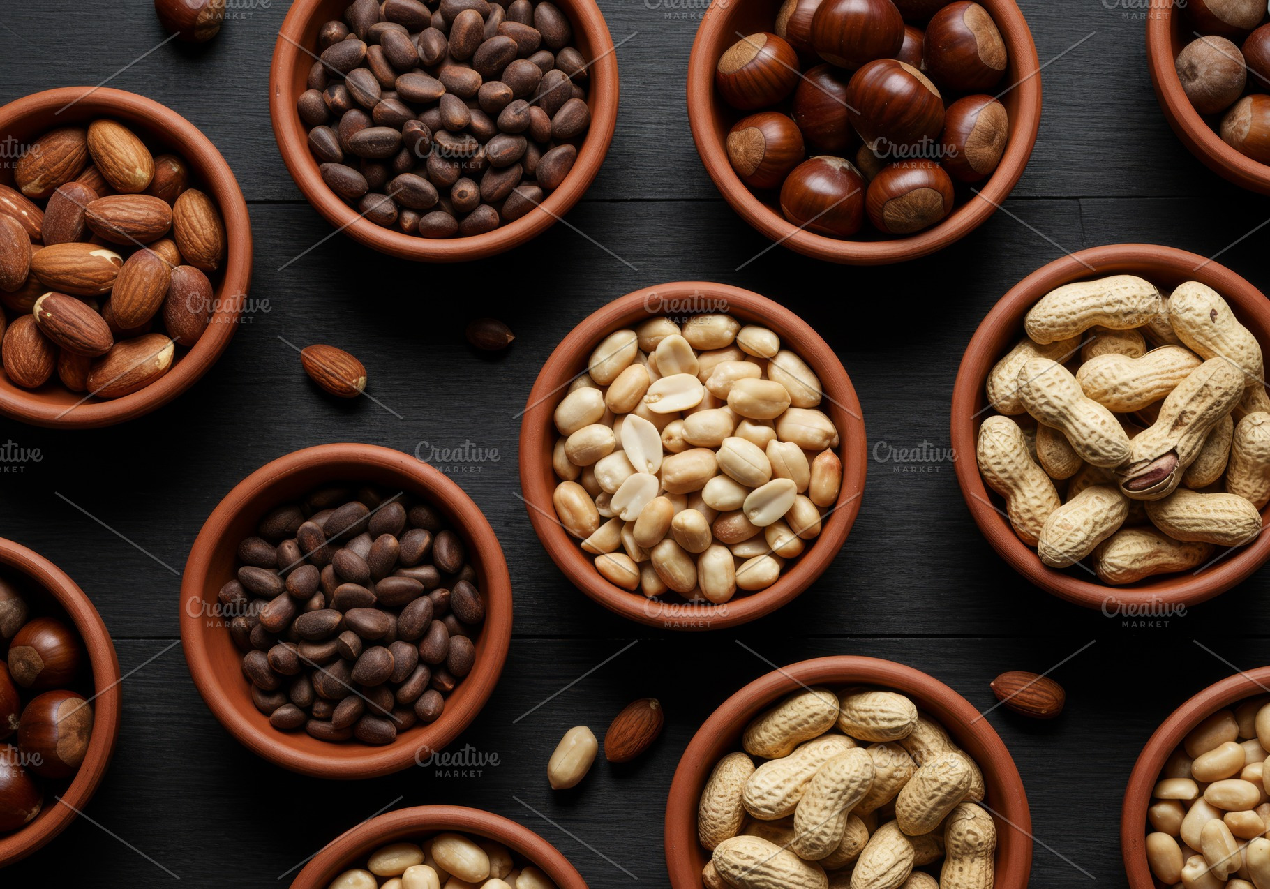 Various types of nuts in clay bowls, a Food & Drink Photo by professorinc