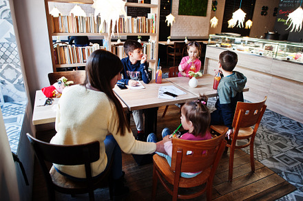 Mother with four kids spending time in cafe. Family lunch in the, a Person Photo by AS photostudio