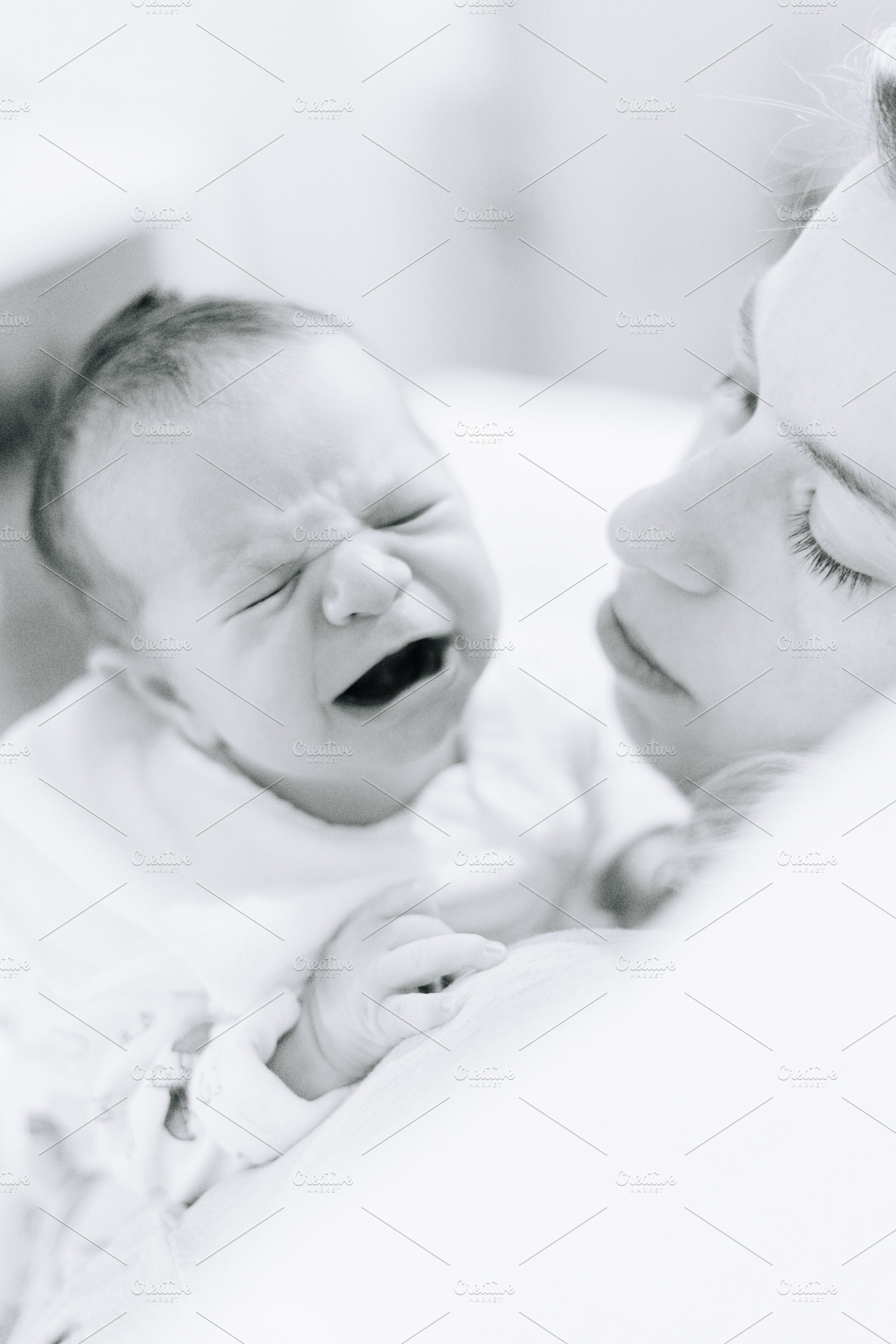 Newborn crying on his mothers shoulder, a Person Photo by rubenchase