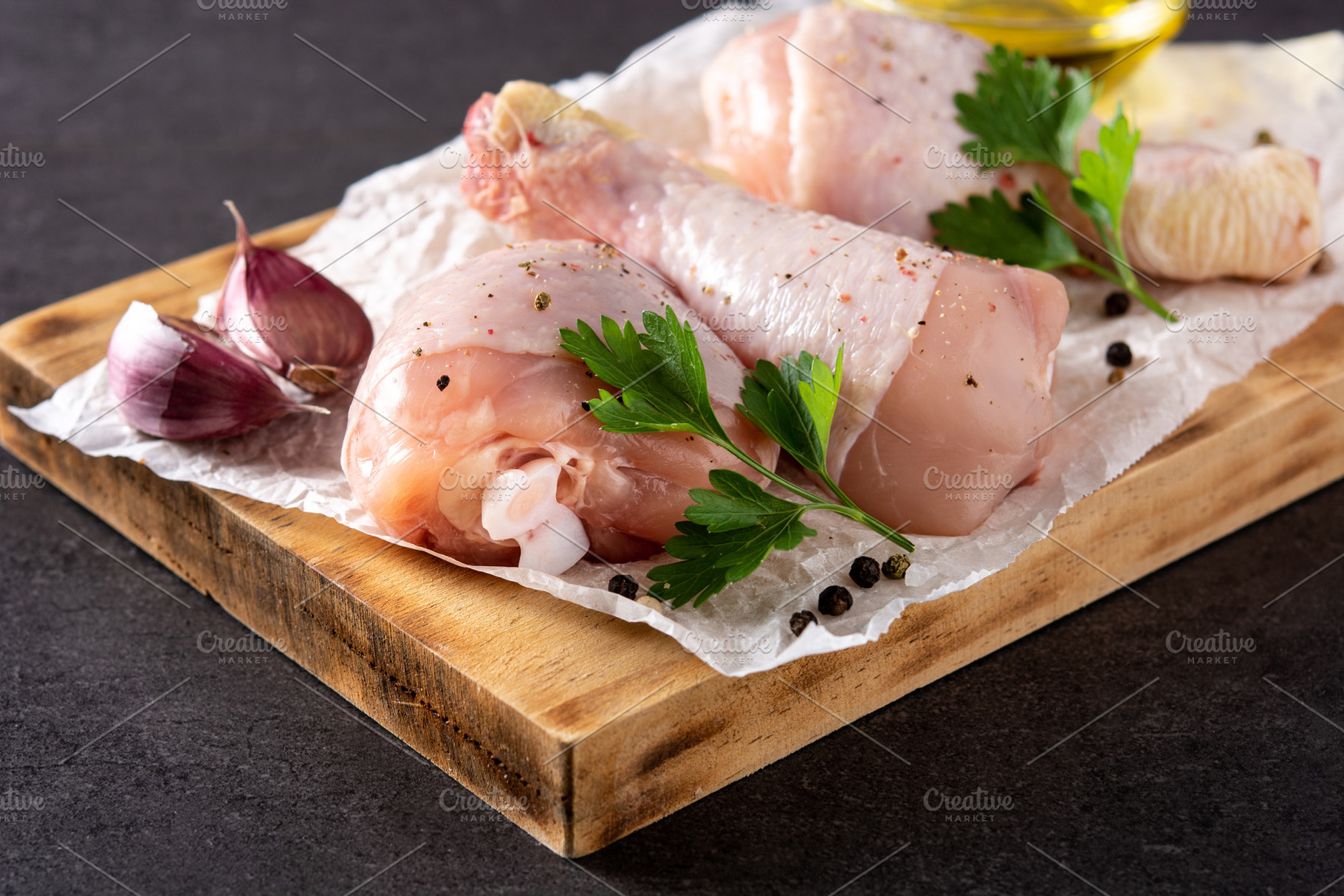 Raw chicken meat legs on black background, a Food & Drink Photo by etorres69